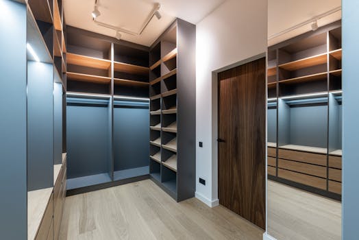 Spacious modern walk-in closet with wooden shelves and sleek finishes.